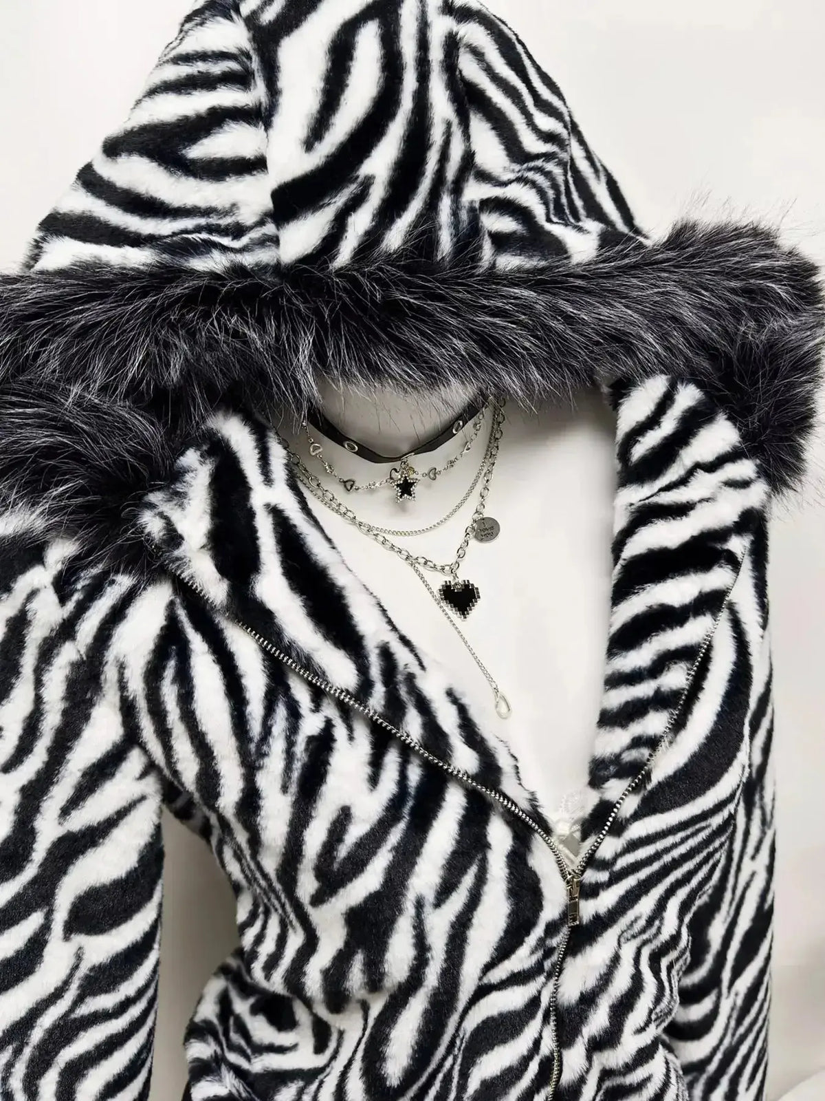 Zebra faux fur hooded zip-up jacket by Plush Fashion Hub featuring a stylish animal print and cozy fur texture.