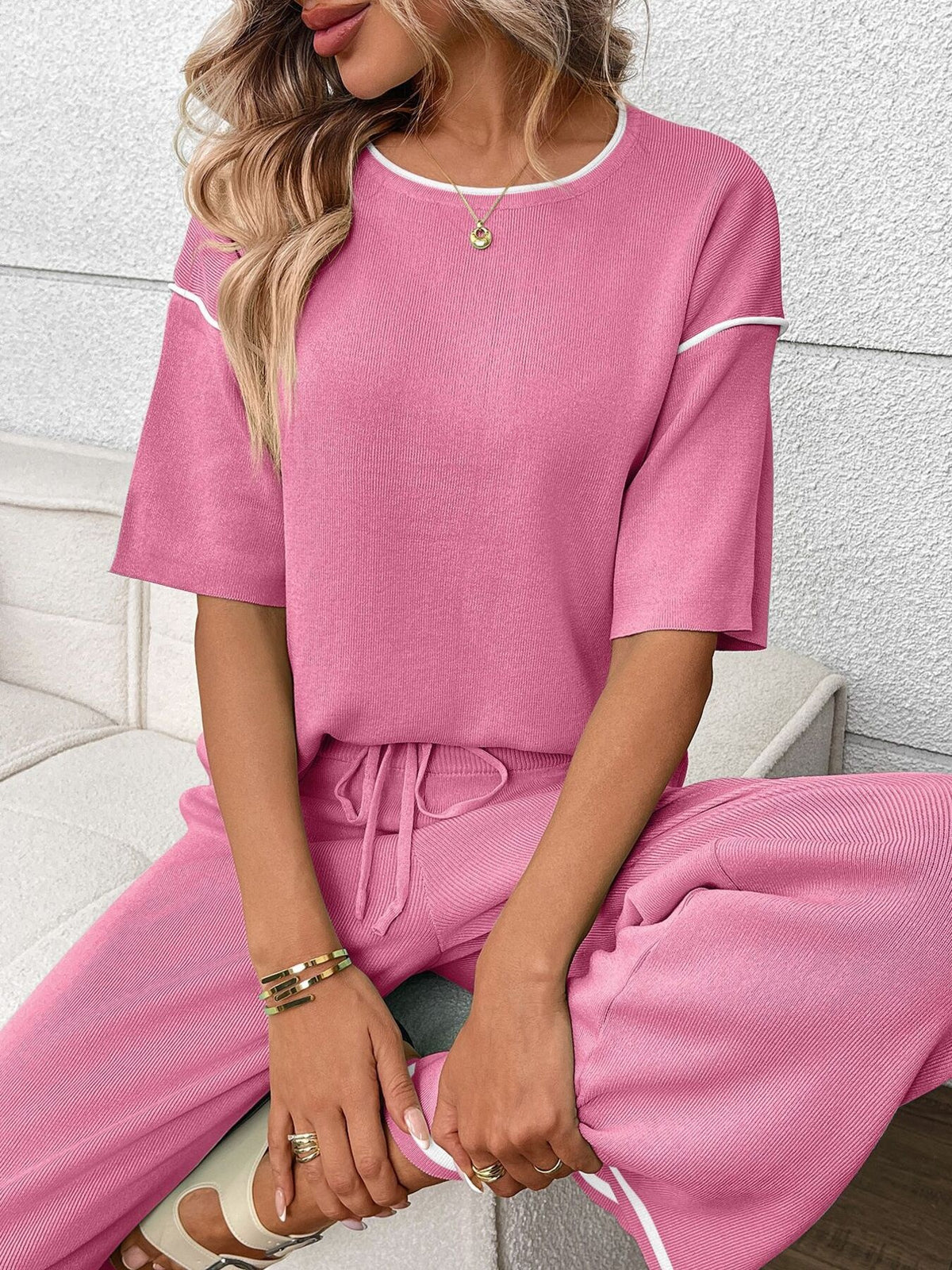 Women’s casual two-piece lounge set with round neck top and drawstring pants from Plush Fashion Hub, shown in soft fabric.