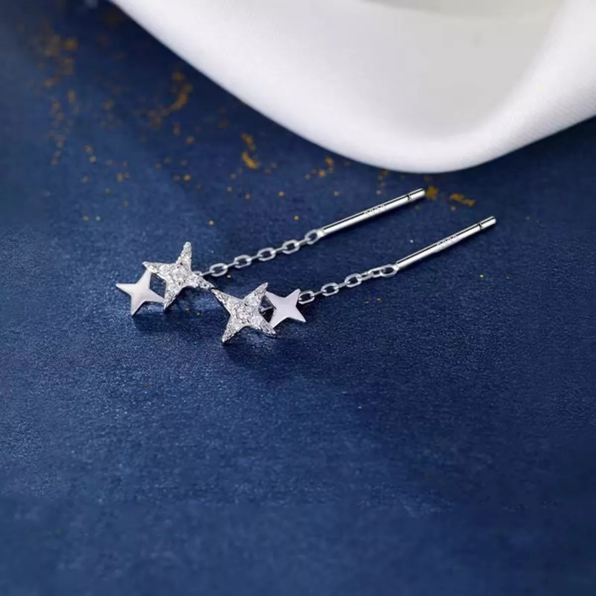 Sterling silver star-shaped earrings with a polished finish, designed for a stylish and elegant look.