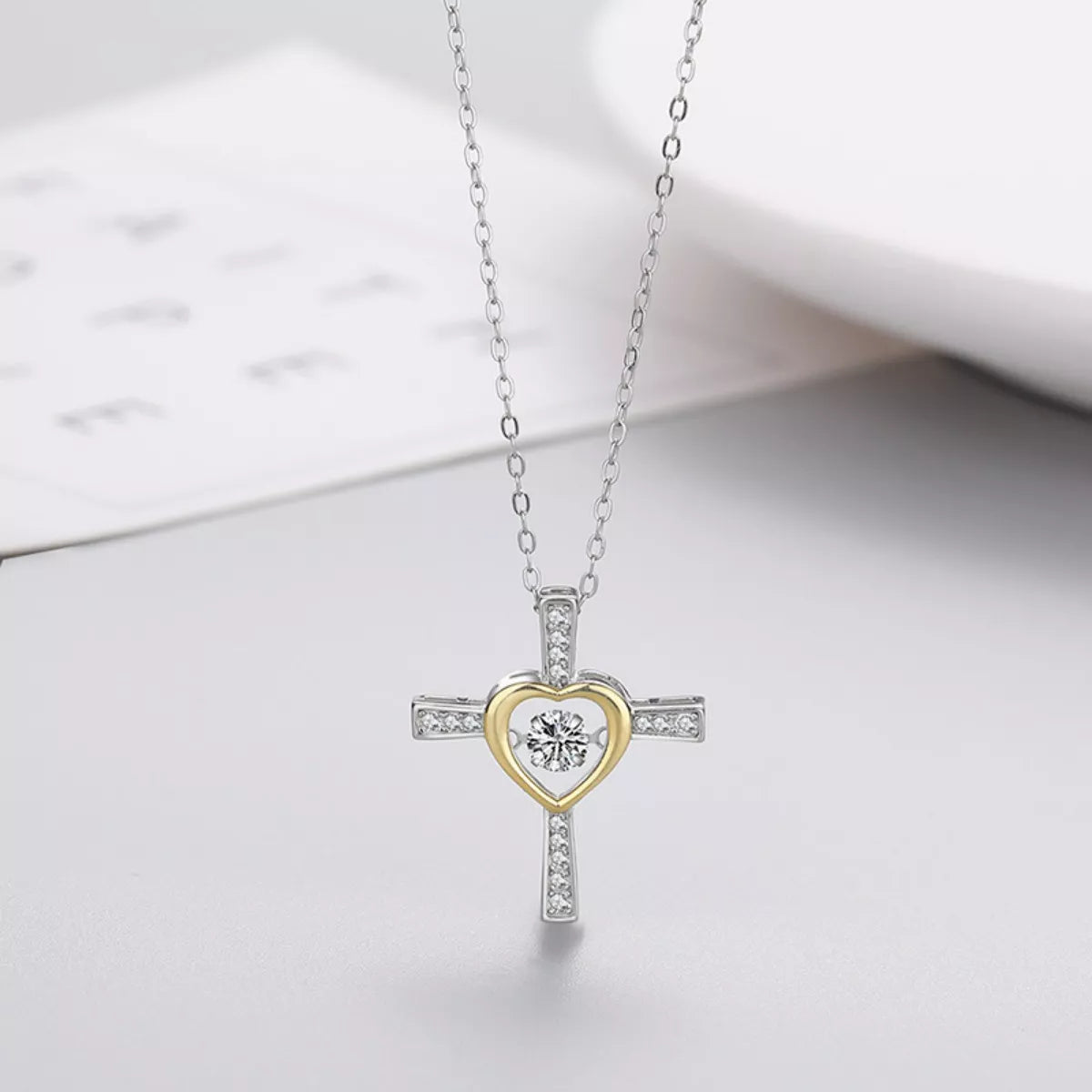 Sterling silver heart and cross necklace from Plush Fashion Hub, featuring a delicate pendant on a fine chain.