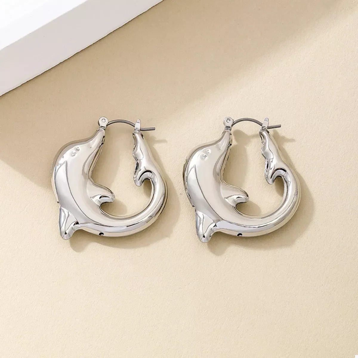 18K gold-plated dolphin hoop earrings with sleek design, featuring shiny gold finish and dolphin-shaped hoops.