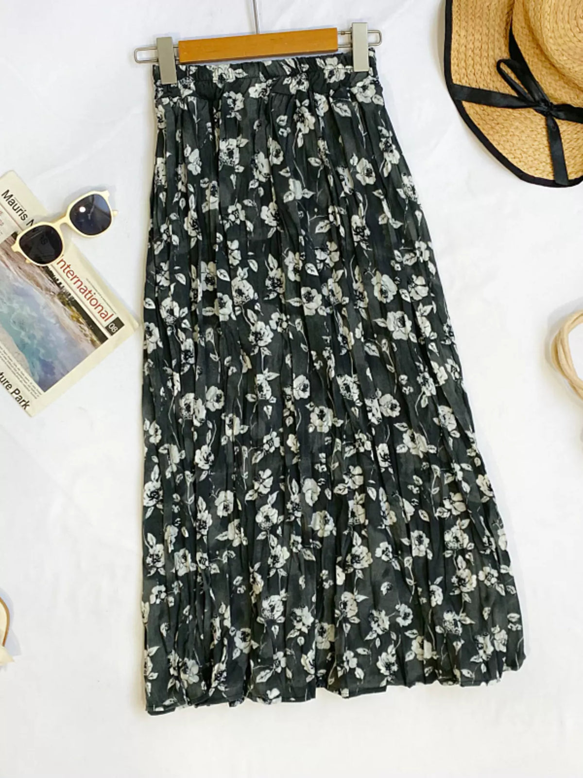 Floral print elastic waist midi skirt from Plush Fashion Hub, flowing fabric with vibrant flower patterns.