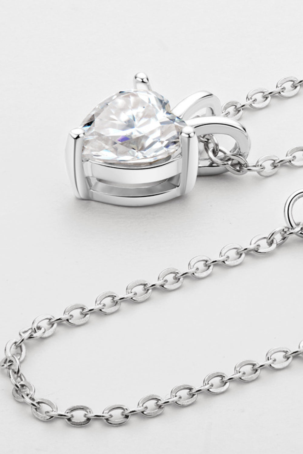 Heart-shaped 1 Carat Moissanite pendant necklace by Plush Fashion Hub featuring a sparkling gemstone on a delicate chain.