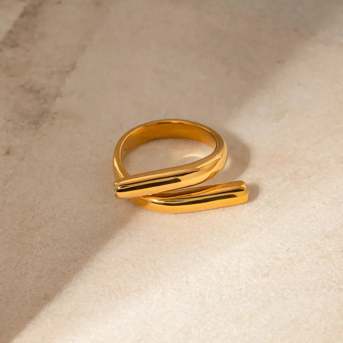 Stainless steel bypass ring from Plush Fashion Hub showing a sleek, polished silver band with a modern design.