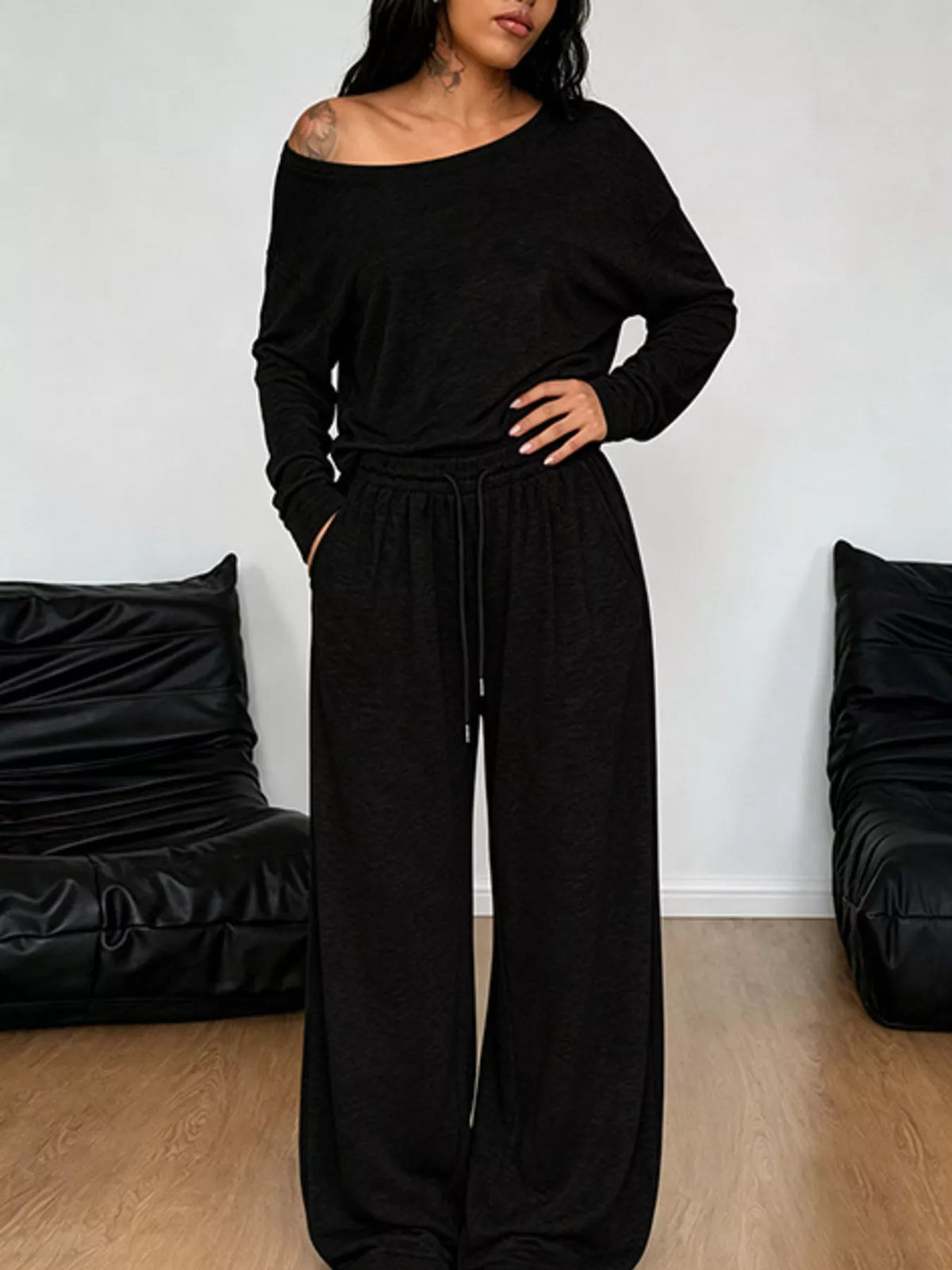 Plus size one-shoulder top and drawstring pants set from Trendsi, featuring a stylish matching ensemble with a relaxed fit.