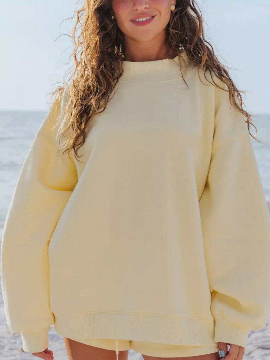 Relaxed fit round neck sweatshirt and shorts set by Trendsi, casual two-piece lounge or activewear outfit in neutral fabric.