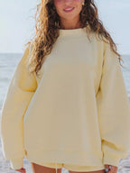Relaxed fit round neck sweatshirt and shorts set by Trendsi, casual two-piece lounge or activewear outfit in neutral fabric.
