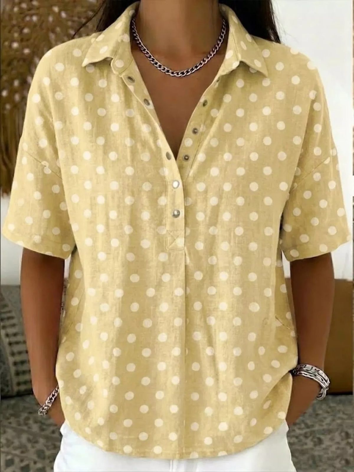 Plus size polka dot short sleeve shirt by Trendsi, featuring a full-coverage fit and classic polka dot pattern, displayed on a model.