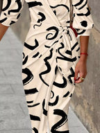 Printed collared neck shirt dress by Trendsi, featuring a button-up front, long sleeves, and a stylish, casual design.