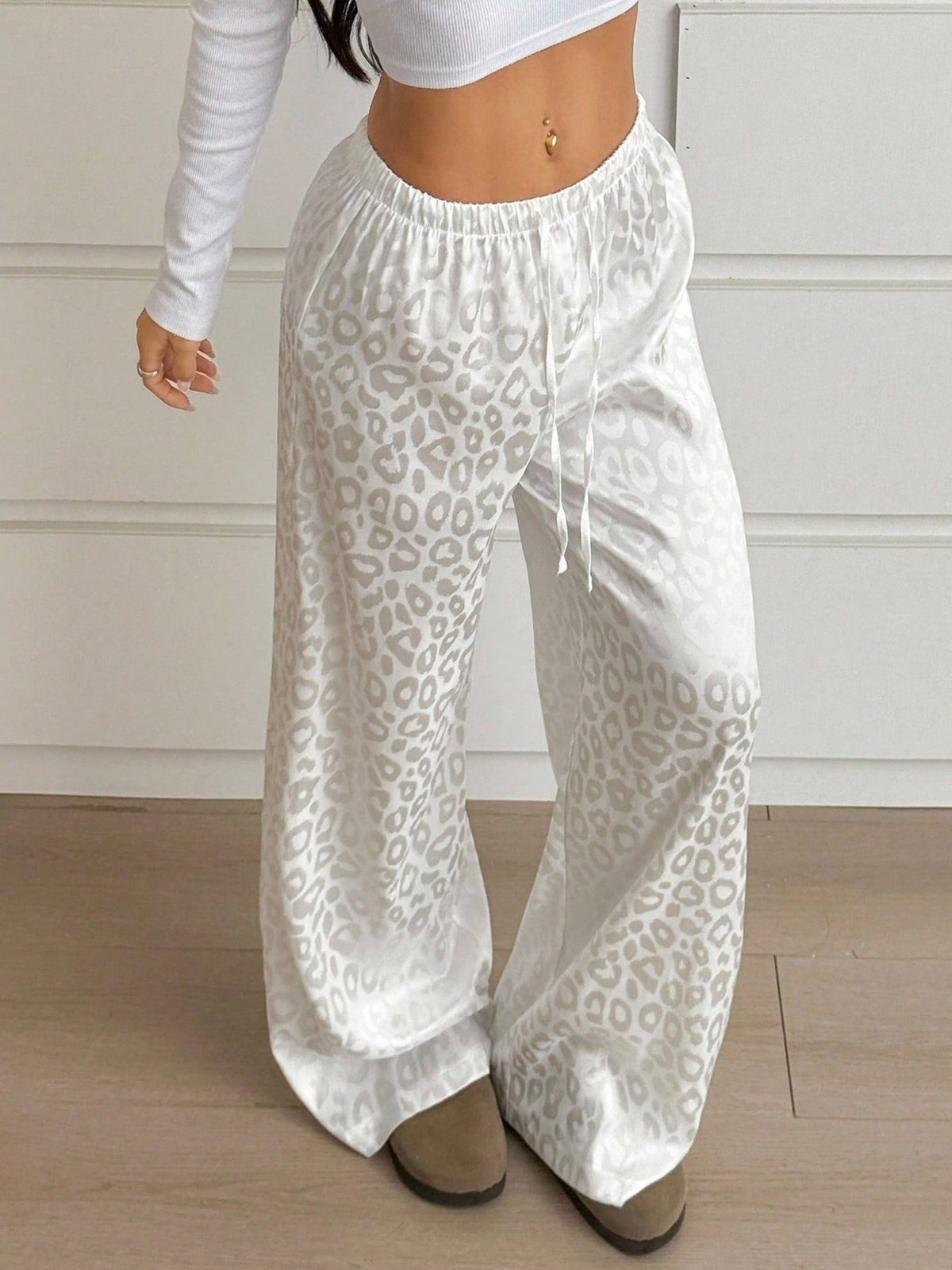 Women’s leopard print wide-leg trousers with an adjustable drawstring waist, stylish and comfortable pants from Plush Fashion Hub.