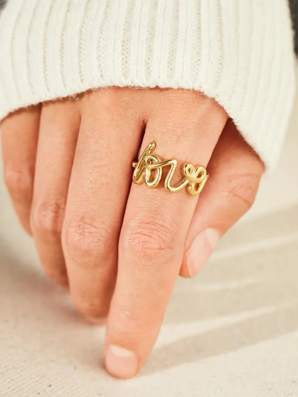 Love 18K gold-plated sterling silver ring with a sleek design, featuring a smooth band and shiny finish.