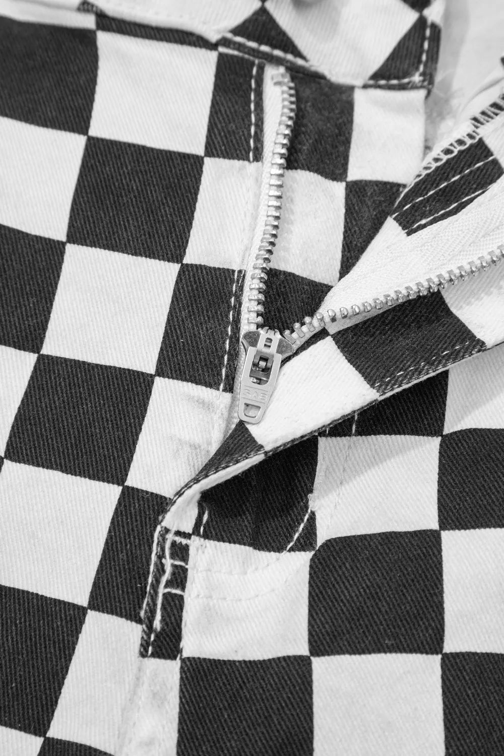 Women’s checkerboard print distressed raw edge cropped jeans by Trendsi, featuring a trendy checkerboard pattern and raw hem details.