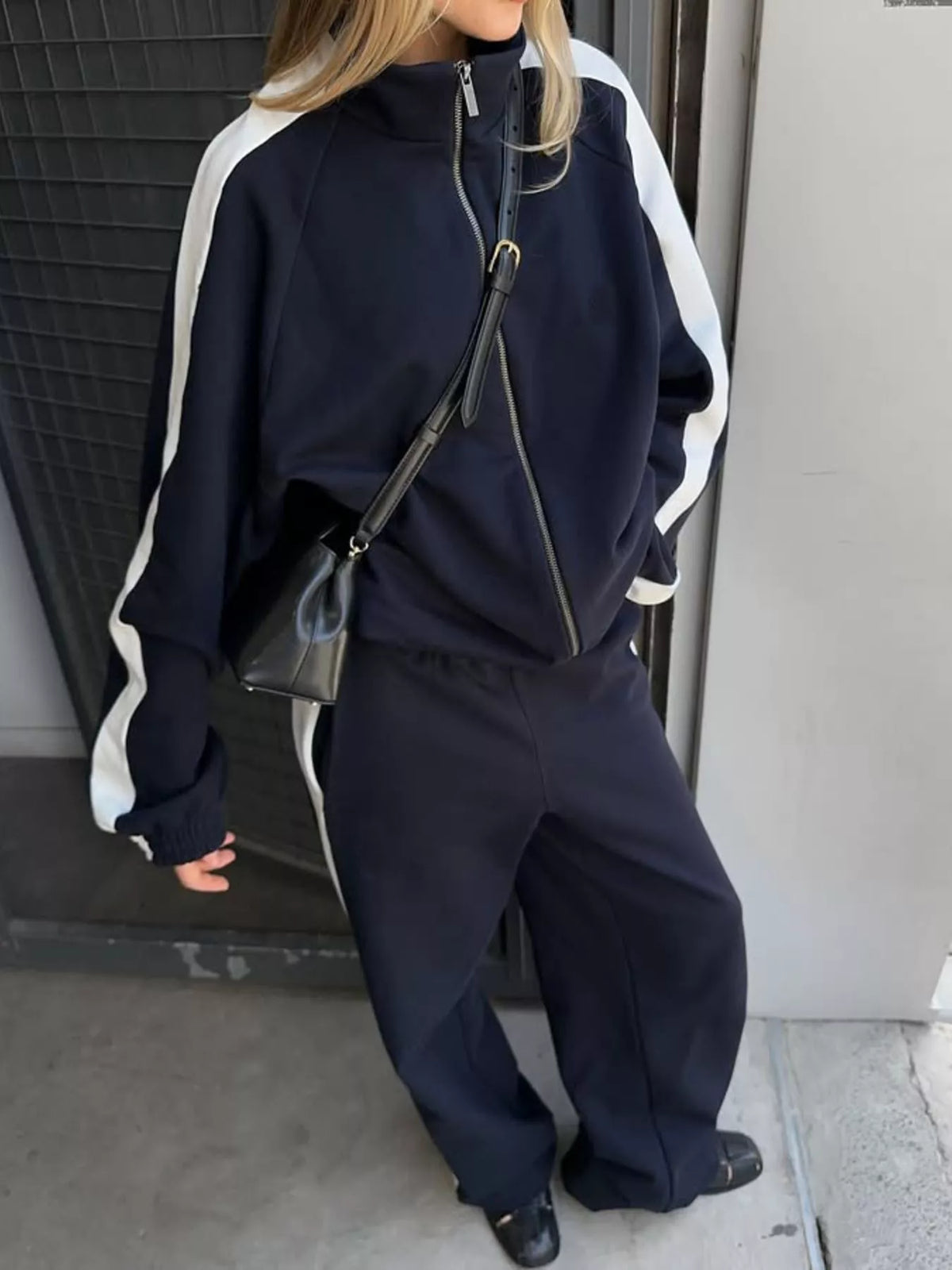 Plush Fashion Hub zip-up long sleeve tracksuit set with comfortable fabric, featuring a stylish design and fitted silhouette.
