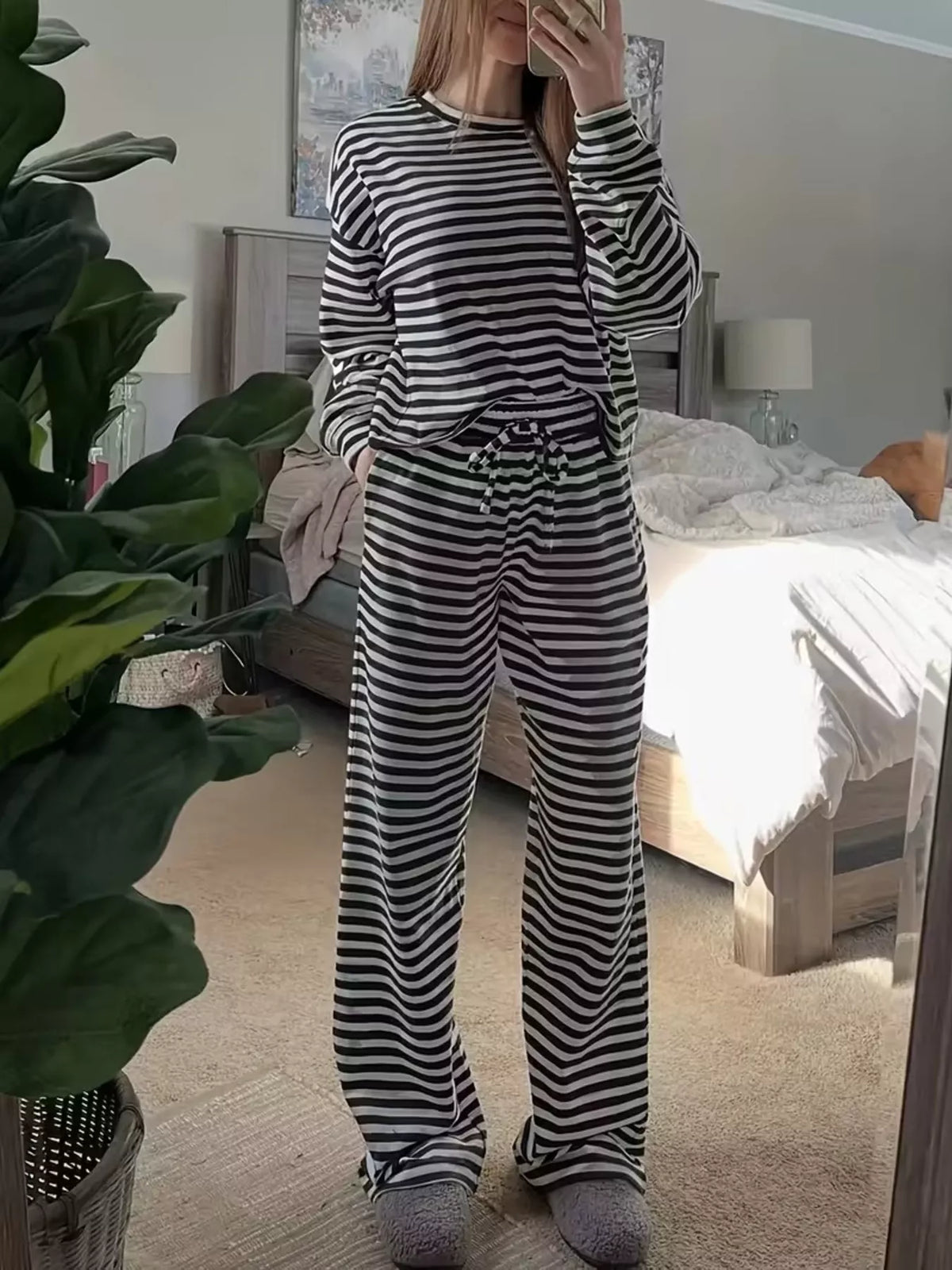 Striped dropped shoulder top and pants set by Trendsi, featuring a stylish casual design with comfortable fit and bold stripe pattern.