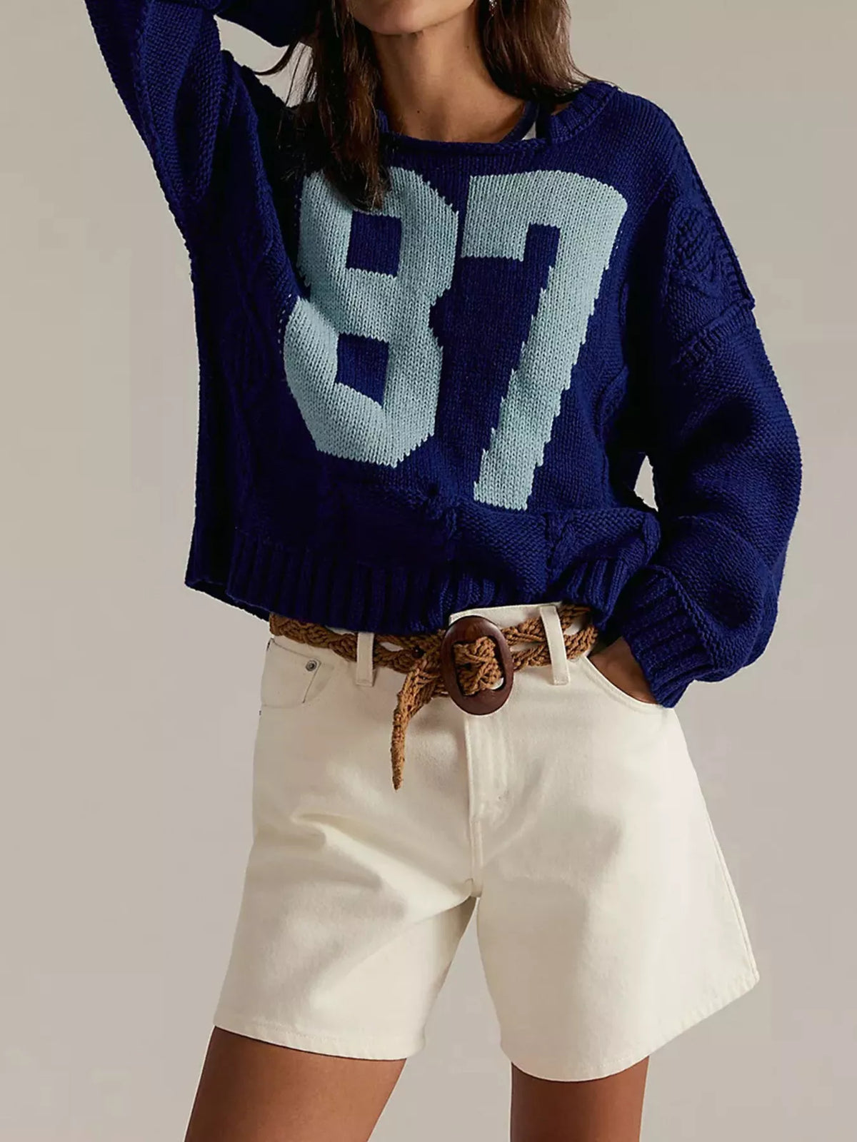 Cable-knit sweater featuring the number 78, in a classic knit pattern, styled as a trendy tops piece by Trendsi.