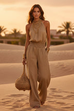 Women's halter-neck backless wide-leg jumpsuit by Plush Fashion Hub, solid color street style with flowing wide-leg design.
