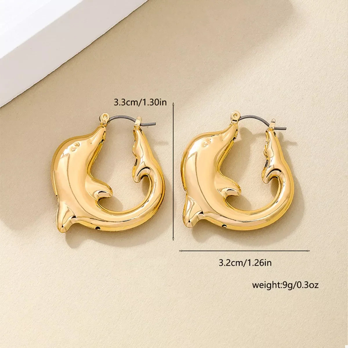 Gold-plated dolphin hoop earrings featuring detailed dolphin designs, stylish jewelry accessory from Plush Fashion Hub.