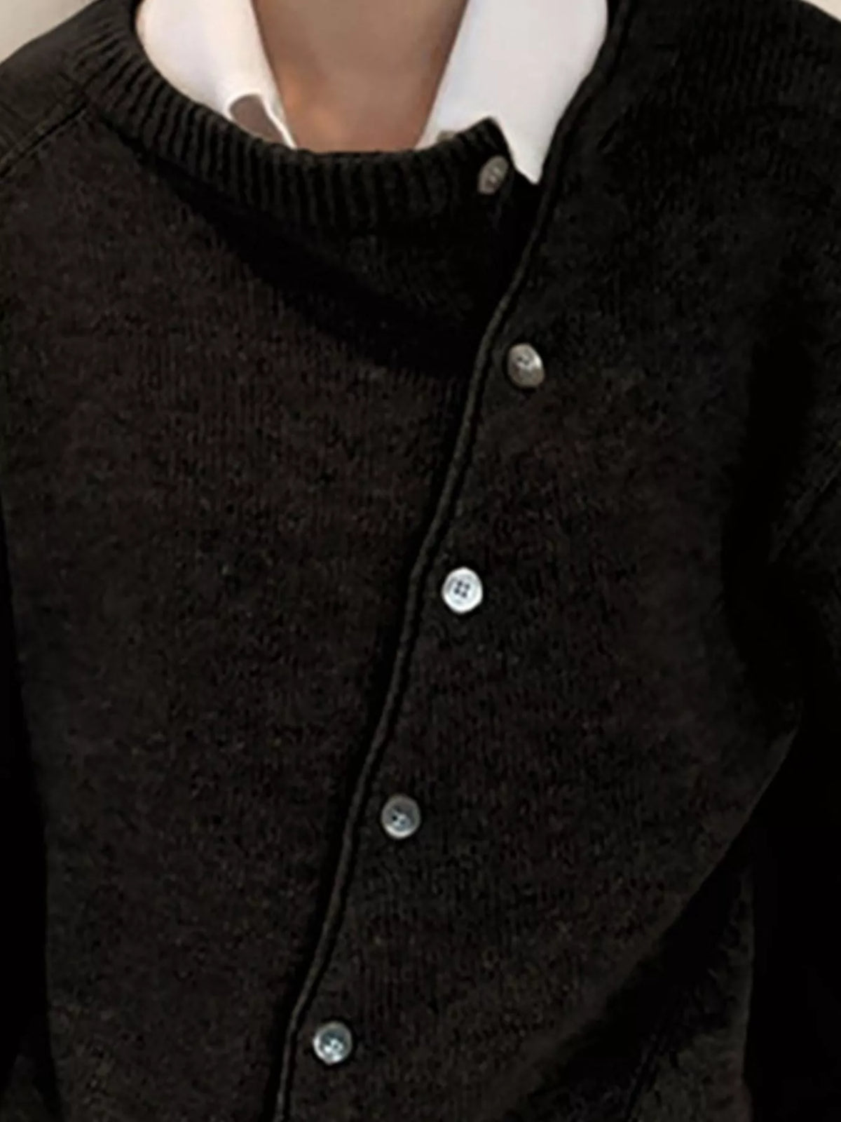 Asymmetric button-down sweater by Trendsi, featuring a stylish uneven hem and cozy knit fabric in a close-up view.