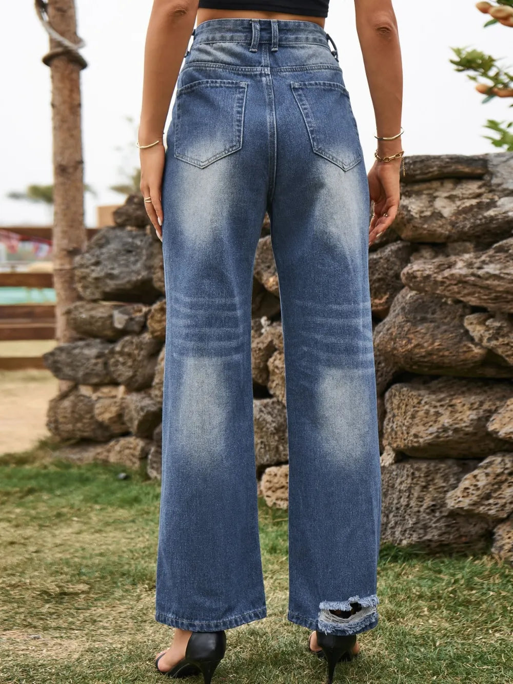 Distressed plush fashion hub denim jeans with front and back pockets, showcasing a stylish, worn-in look and classic denim stitching.