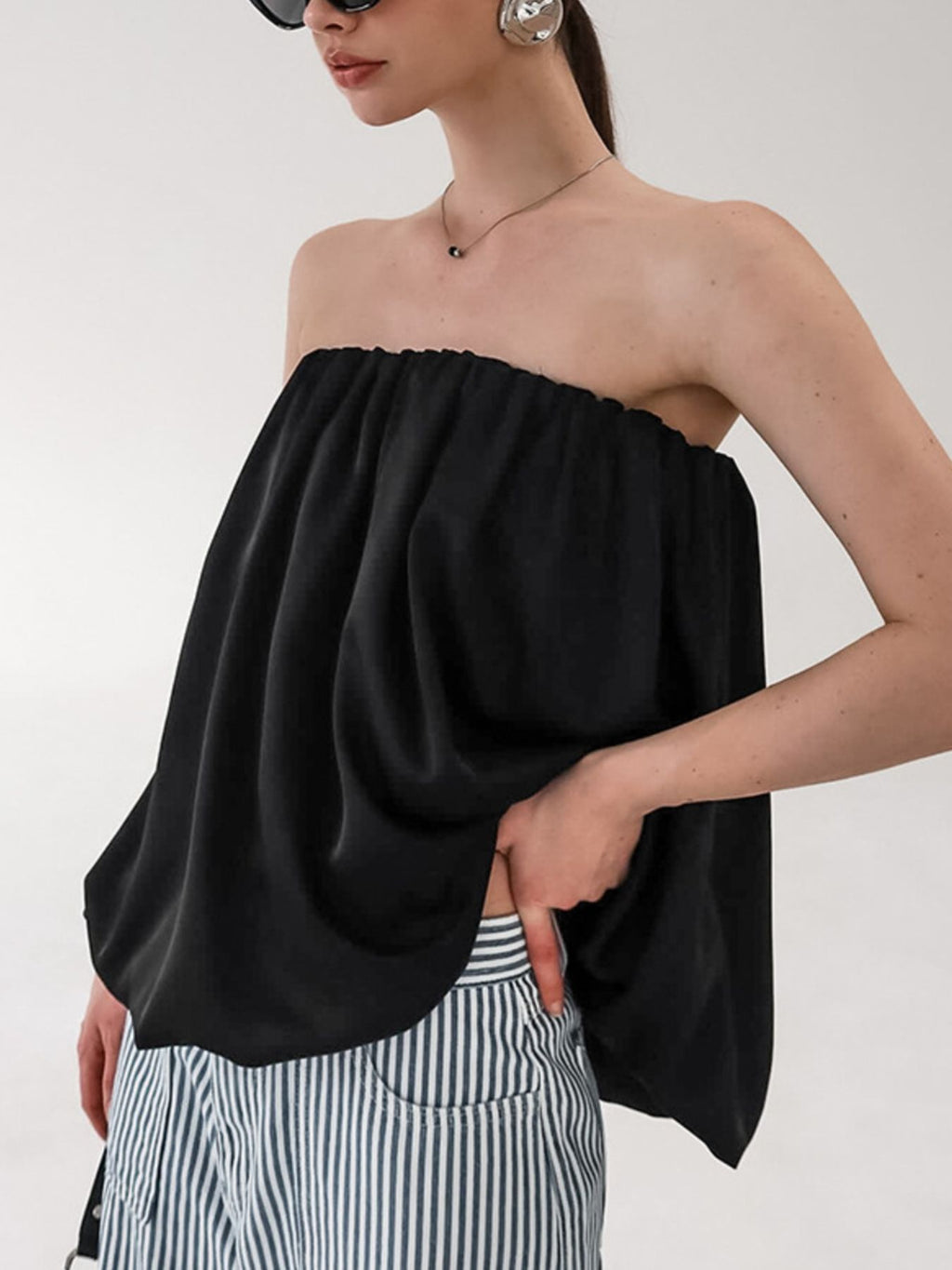 Women's strapless bubble hem tube top by Trendsi, featuring a sleek minimalist design, perfect for trendy, minimalist fashion.