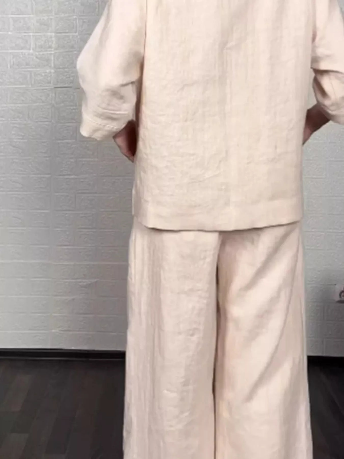 Plus size full V-neck long sleeve top and matching pants set by Trendsi, shown in a comfortable, stylish matching outfit.