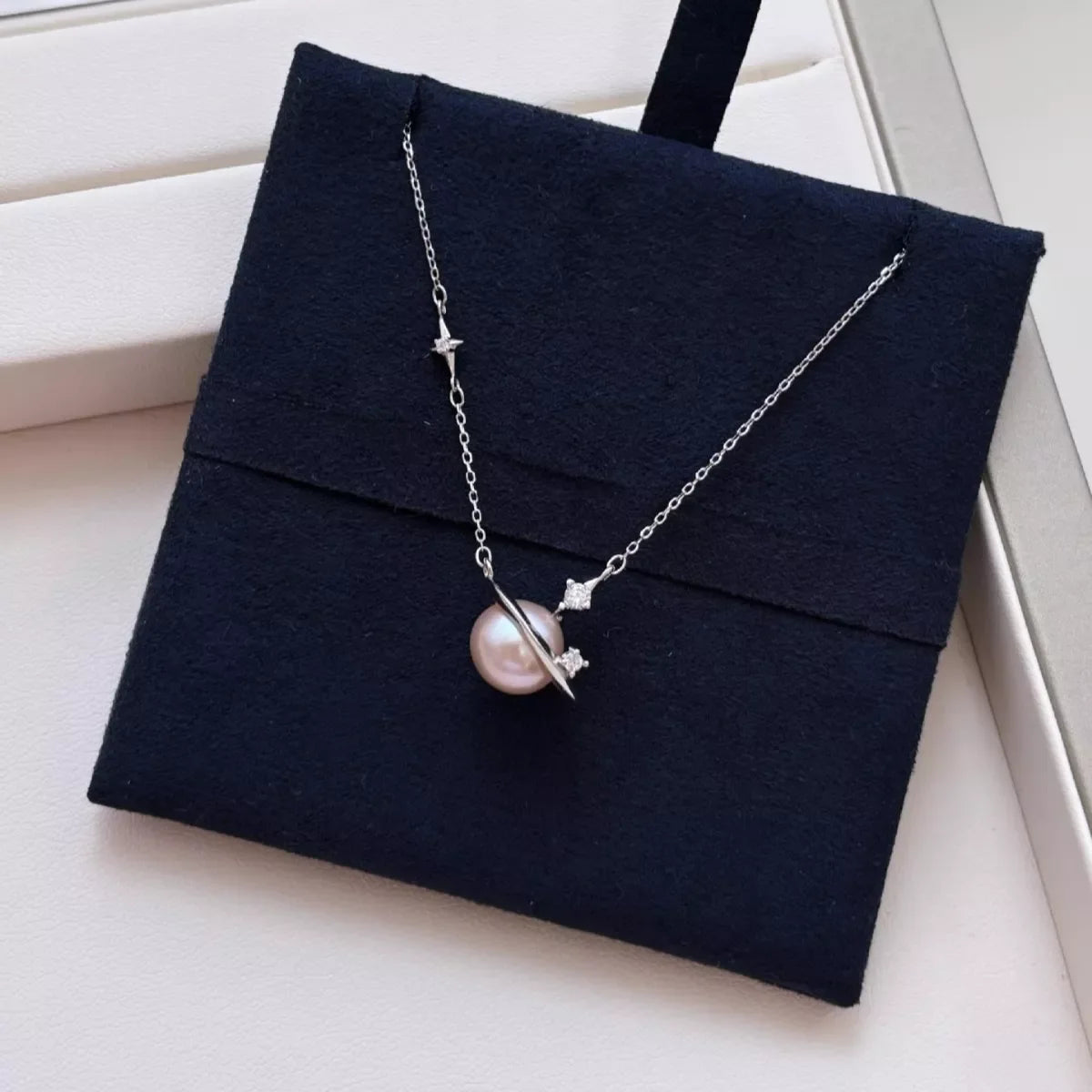 Plush Fashion Hub Planet Pearl pendant necklace featuring a shimmering pearl charm on a delicate chain.