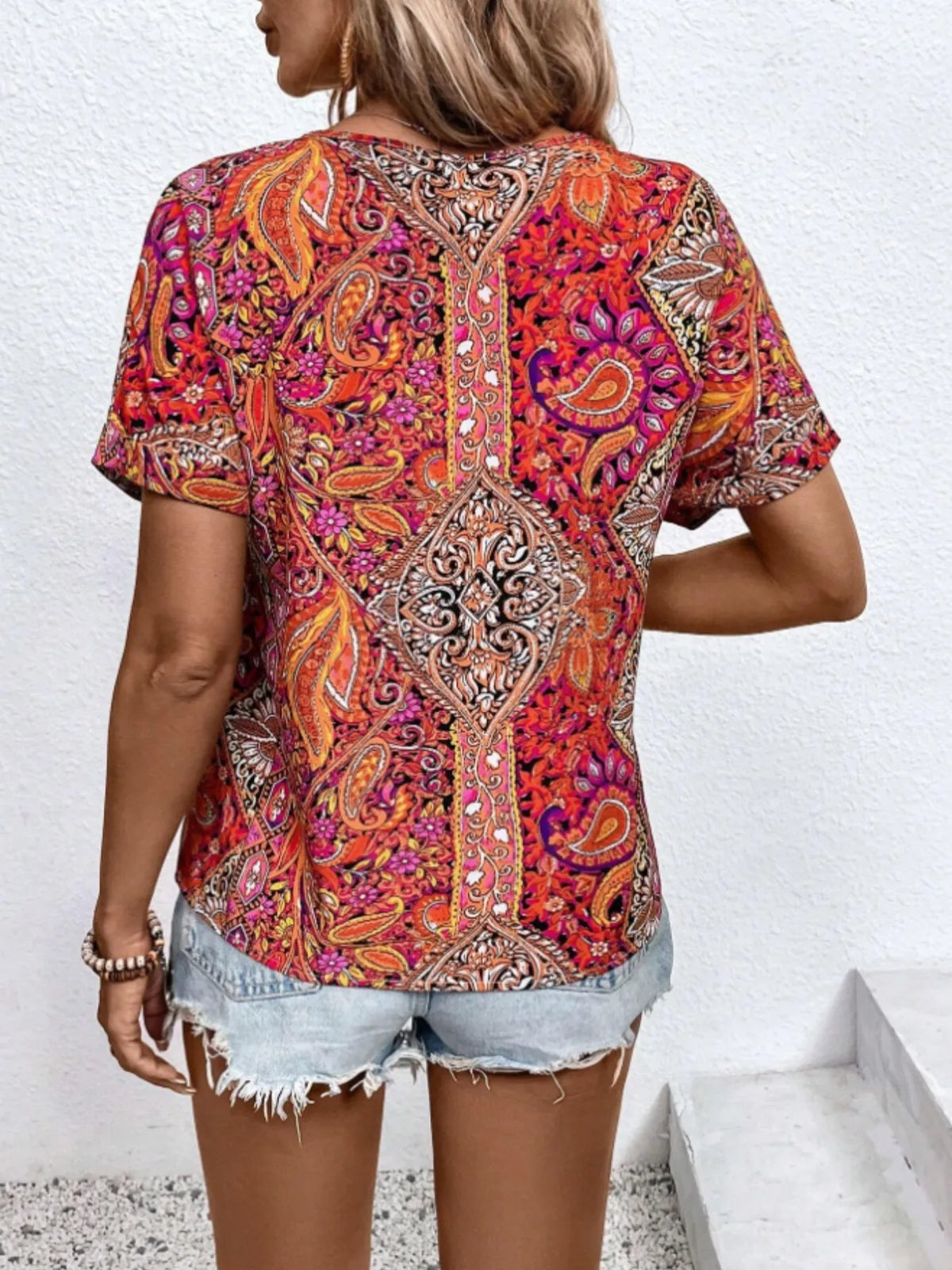 Plush Fashion Hub bohemian paisley V-neck short sleeve T-shirt with vibrant patterns and comfortable fit, displayed on a model.