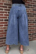 High-waisted wide-leg button-fly jeans in classic cotton denim from Trendsi, shown on a model with a relaxed fit and stylish design.