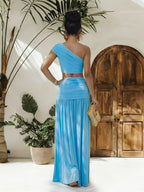 One-shoulder top and ruched maxi skirt set by Trendsi, featuring stylish design and comfortable fit in a coordinated outfit.