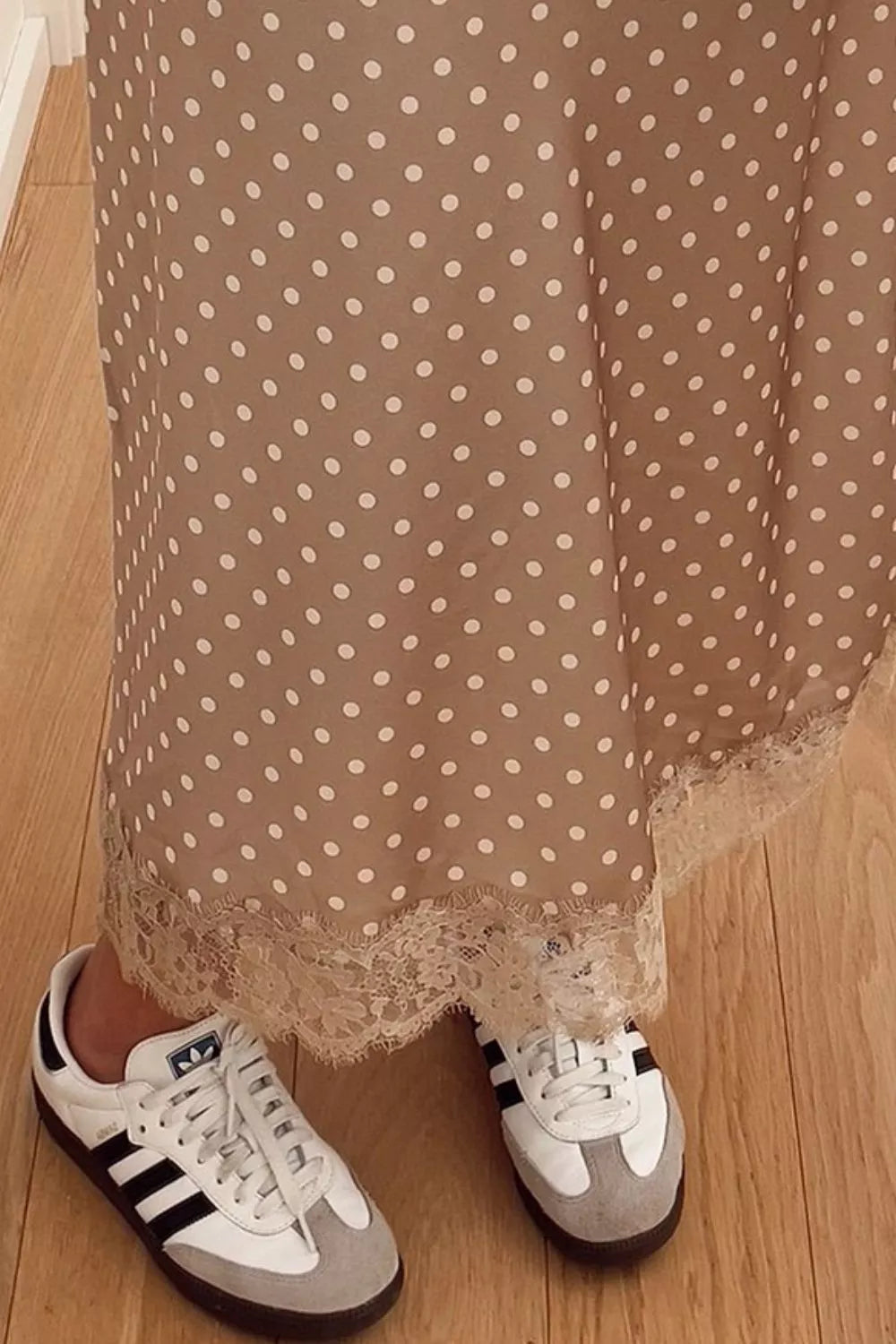Women's polka dot lace trim midi skirt by Trendsi featuring a flowing silhouette and delicate lace details.