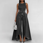 Women’s sleeveless wide-leg denim jumpsuit by FitiqueFit featuring a casual crew neck and relaxed fit, displayed on a model.