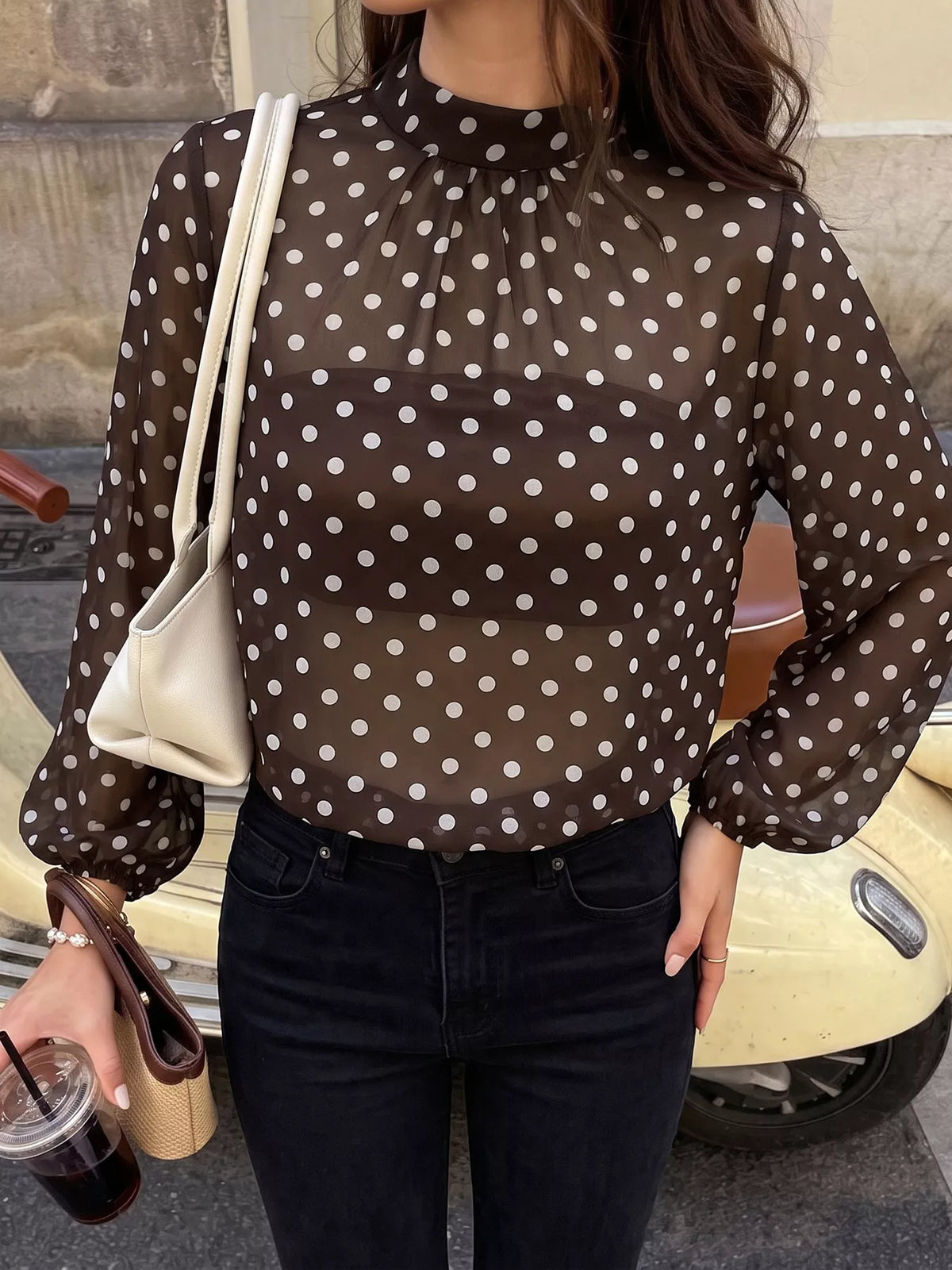 Polka dot mock neck long sleeve blouse by Trendsi, featuring a stylish design with a fitted silhouette and classic pattern.