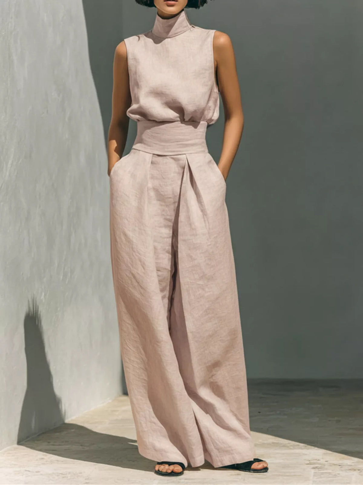 Plus size full length sleeveless wide-leg jumpsuit with smocked waist from Trendsi, featuring a flowy silhouette and comfortable fit.