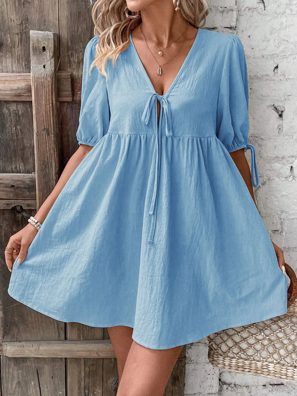 Cotton V-neck tie-front mini dress with puff sleeves from Plush Fashion Hub, shown in a stylish, casual design.
