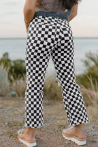 Women's checkerboard print distressed raw edge cropped jeans from Trendsi, featuring a trendy pattern and frayed hem detail.