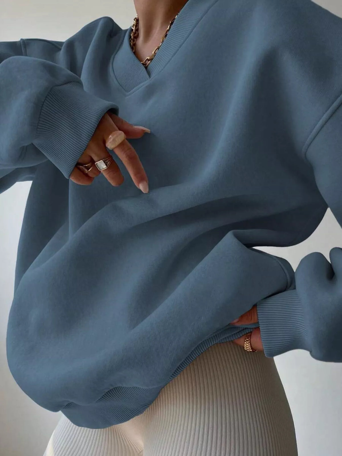 Oversized dropped shoulder long sleeve sweatshirt by Trendsi, featuring a relaxed fit and soft fabric, shown in a neutral color.
