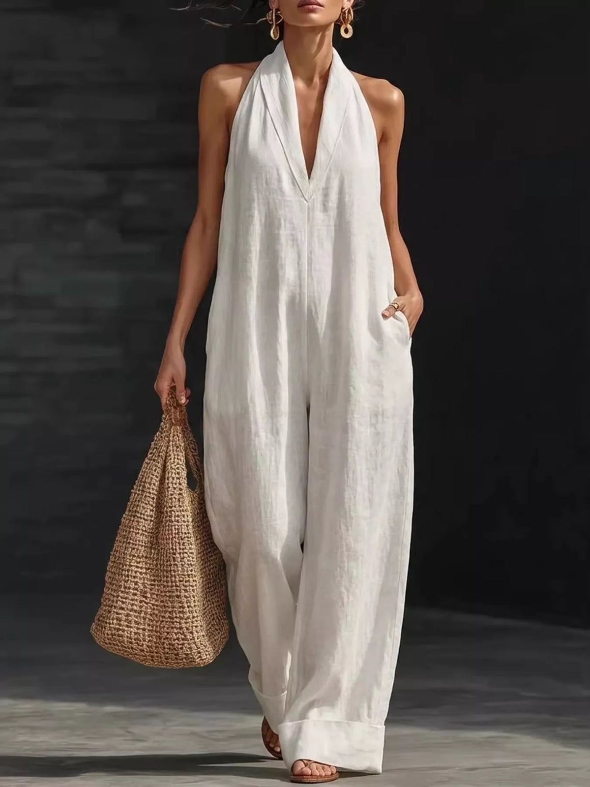Plush Fashion Hub halter neck wide leg jumpsuit displayed on a model, showcasing its stylish design and flowing silhouette.