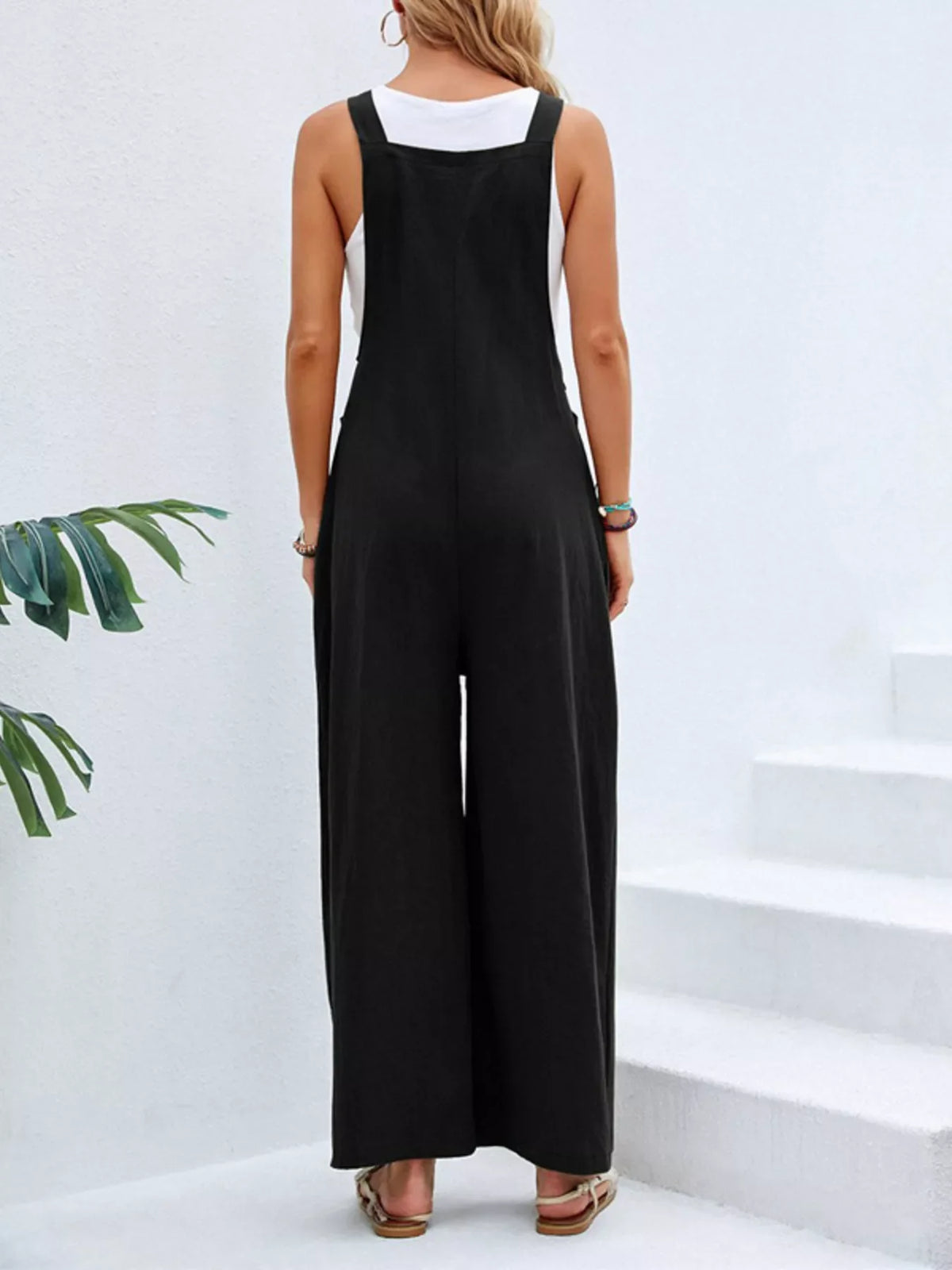 Plus size casual wide-leg jumpsuit with pockets by Plush Fashion Hub, featuring a full-size relaxed fit and comfortable design.