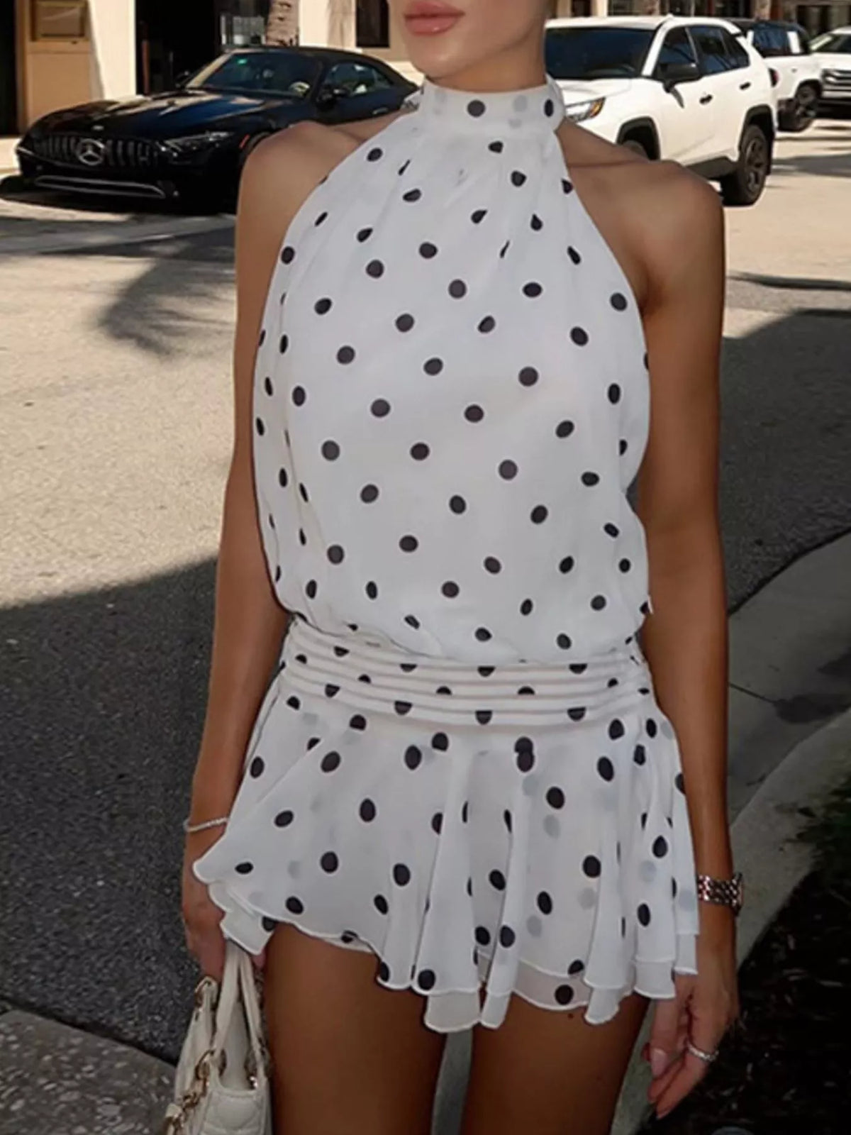 Polka dot halter neck ruffle dress by Plush Fashion Hub, featuring a playful pattern and flowing ruffle details.