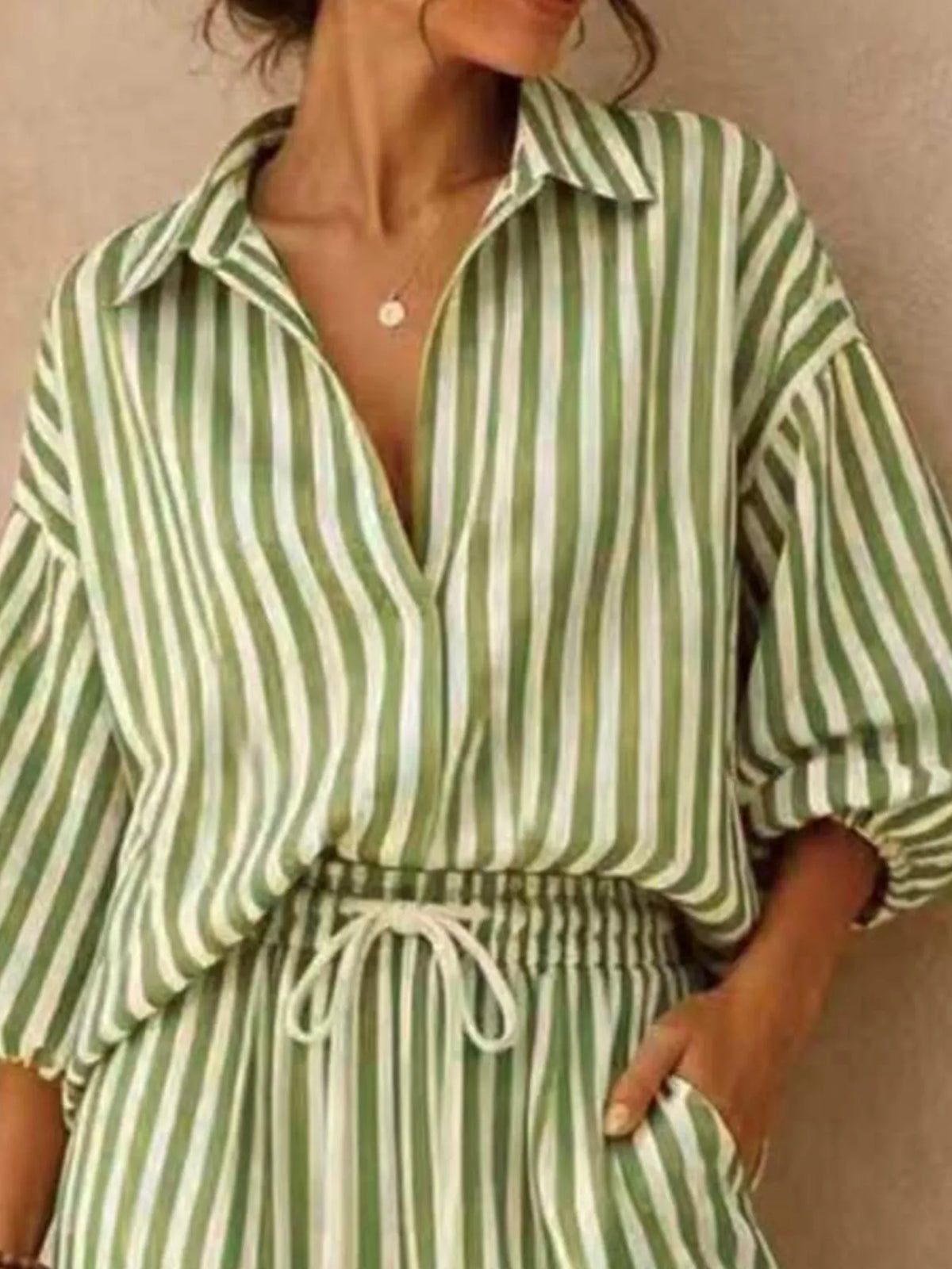 Plus size striped puff sleeve shirt and wide-leg drawstring pants set from Trendsi, featuring stylish, comfortable matching top and pants.