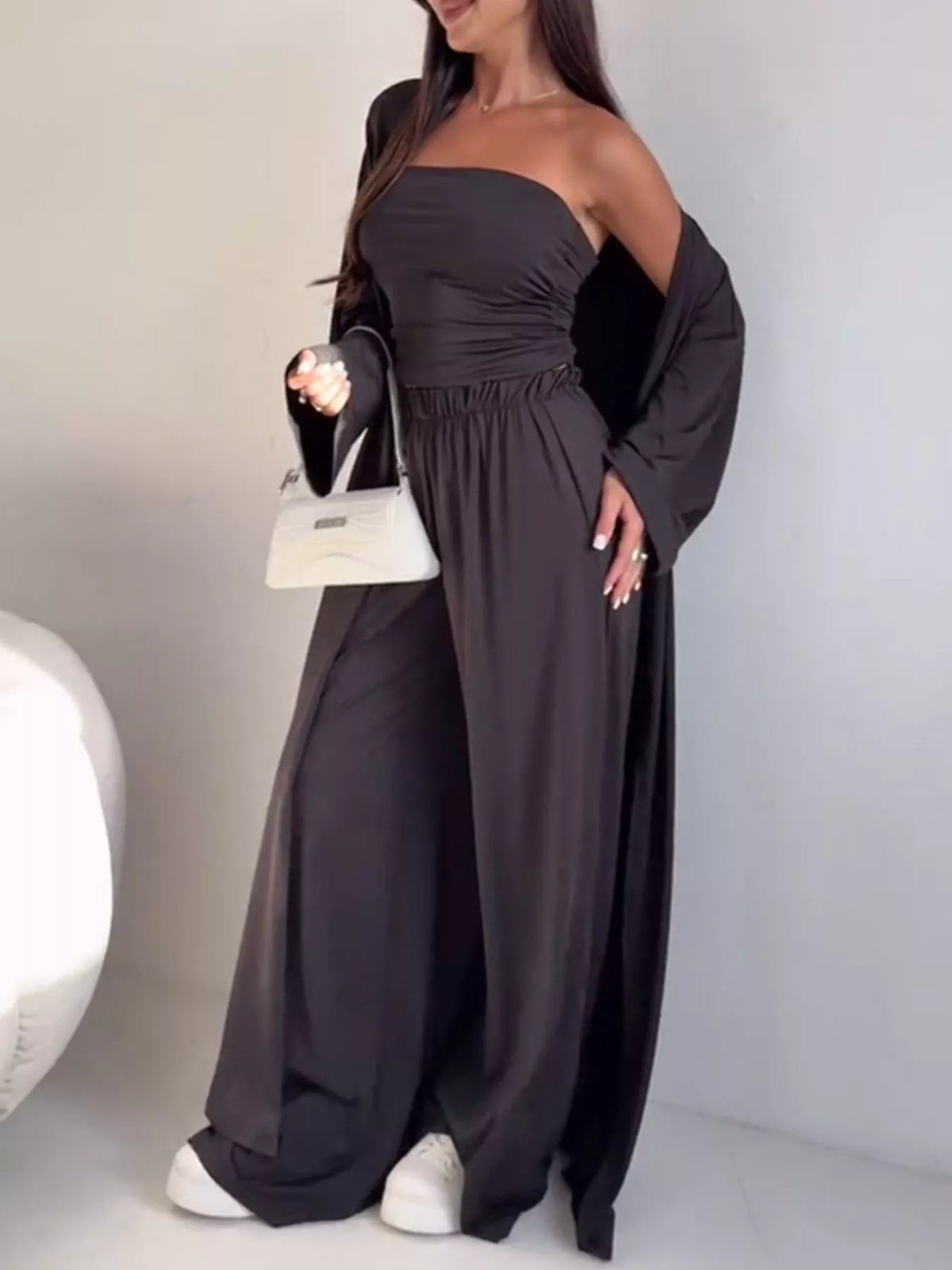 Trendsi chic three-piece set featuring a strapless ruched crop top, wide-leg pants, and matching cardigan, stylish and coordinated.