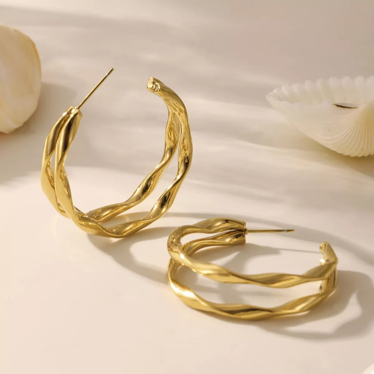 Gold-plated chunky twisted hoop earrings from Plush Fashion Hub, showcasing bold, stylish jewelry with a textured twist design.