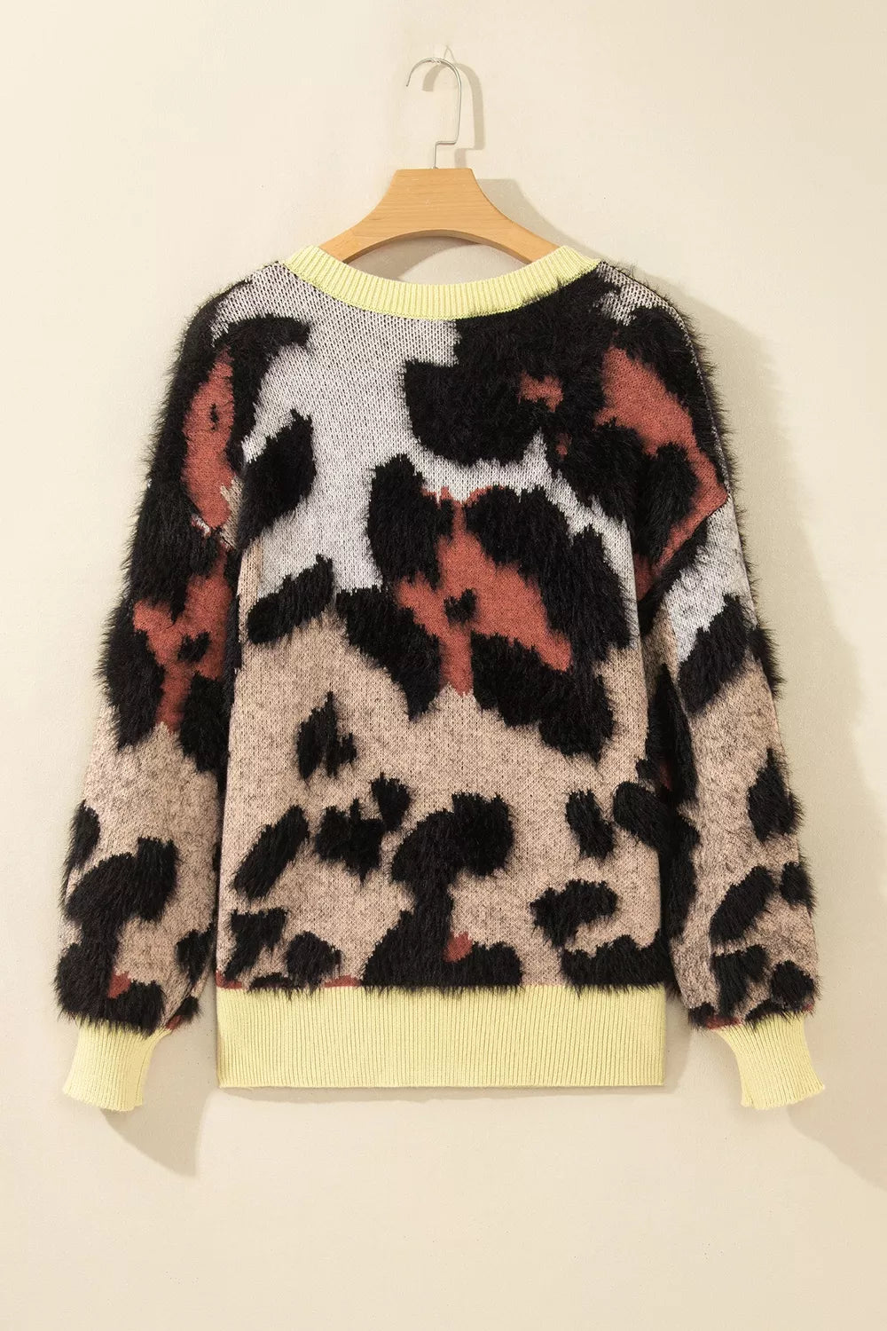 Leopard print drop shoulder long sleeve sweater with round neck from Trendsi, featuring bold animal print and cozy knit fabric.