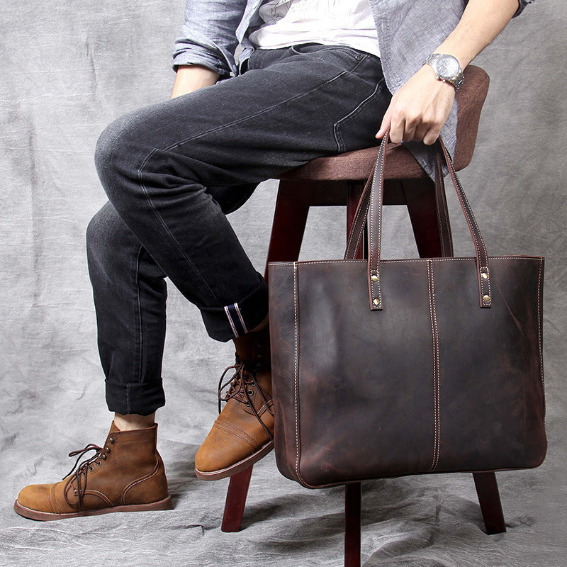 Simple retro Pi-Mart men's large-capacity cowhide handbag with a classic design and spacious interior for everyday use.