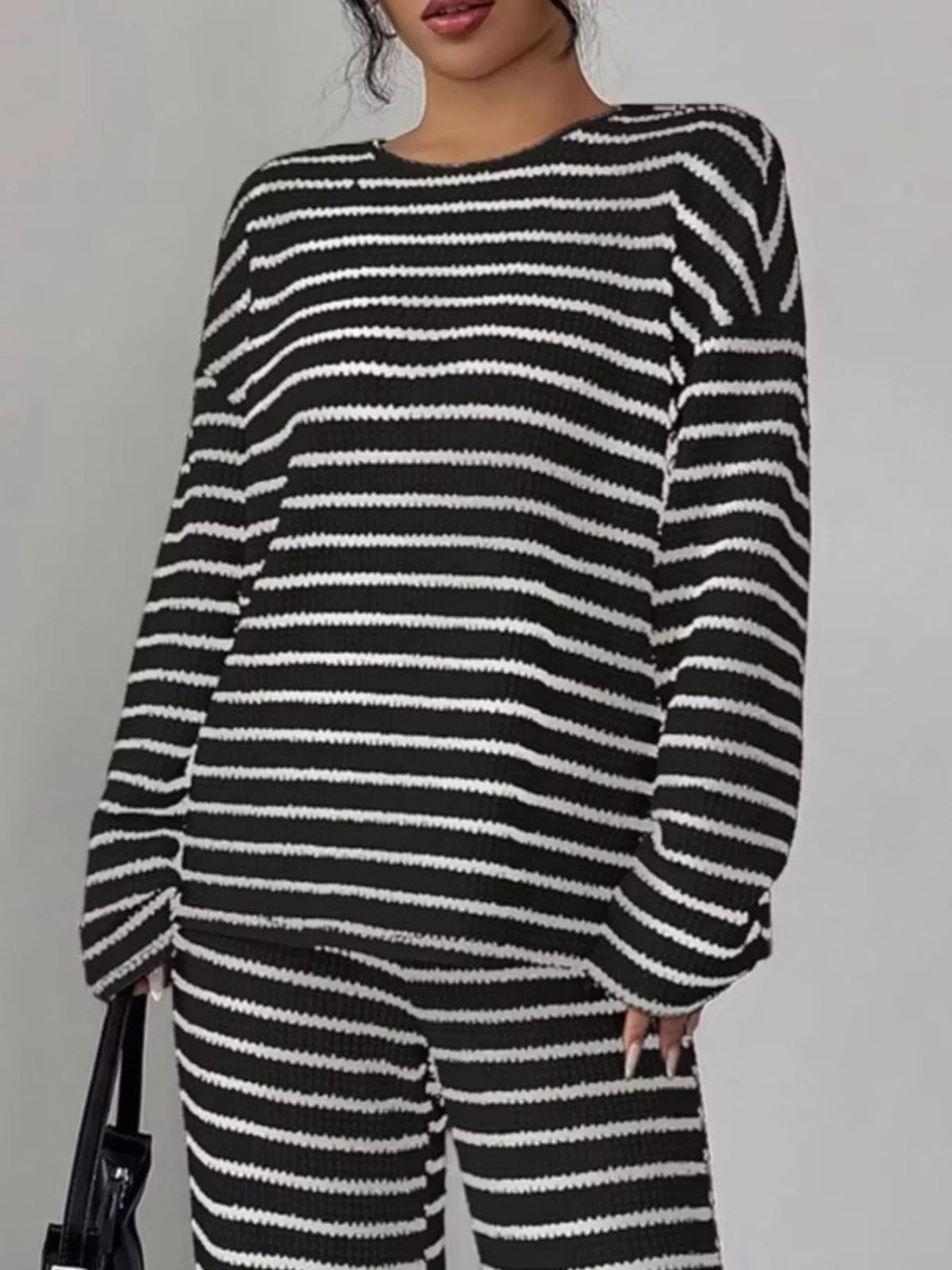 Striped knit dropped shoulder top and pants set from Trendsi, featuring a cozy, casual style with a relaxed fit.