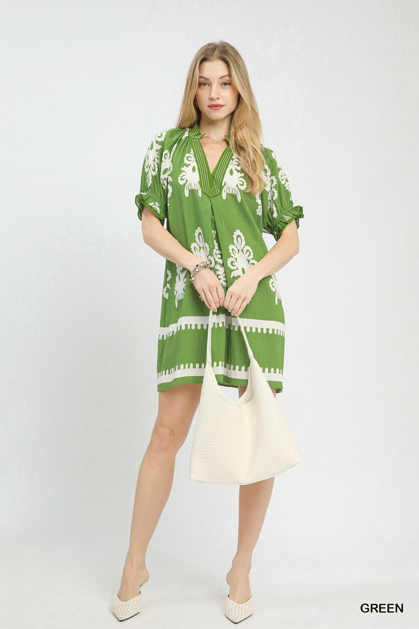 Women's two-tone border print flowy mini dress by Trendsi, casual summer boho style, lightweight and comfortable for warm weather.