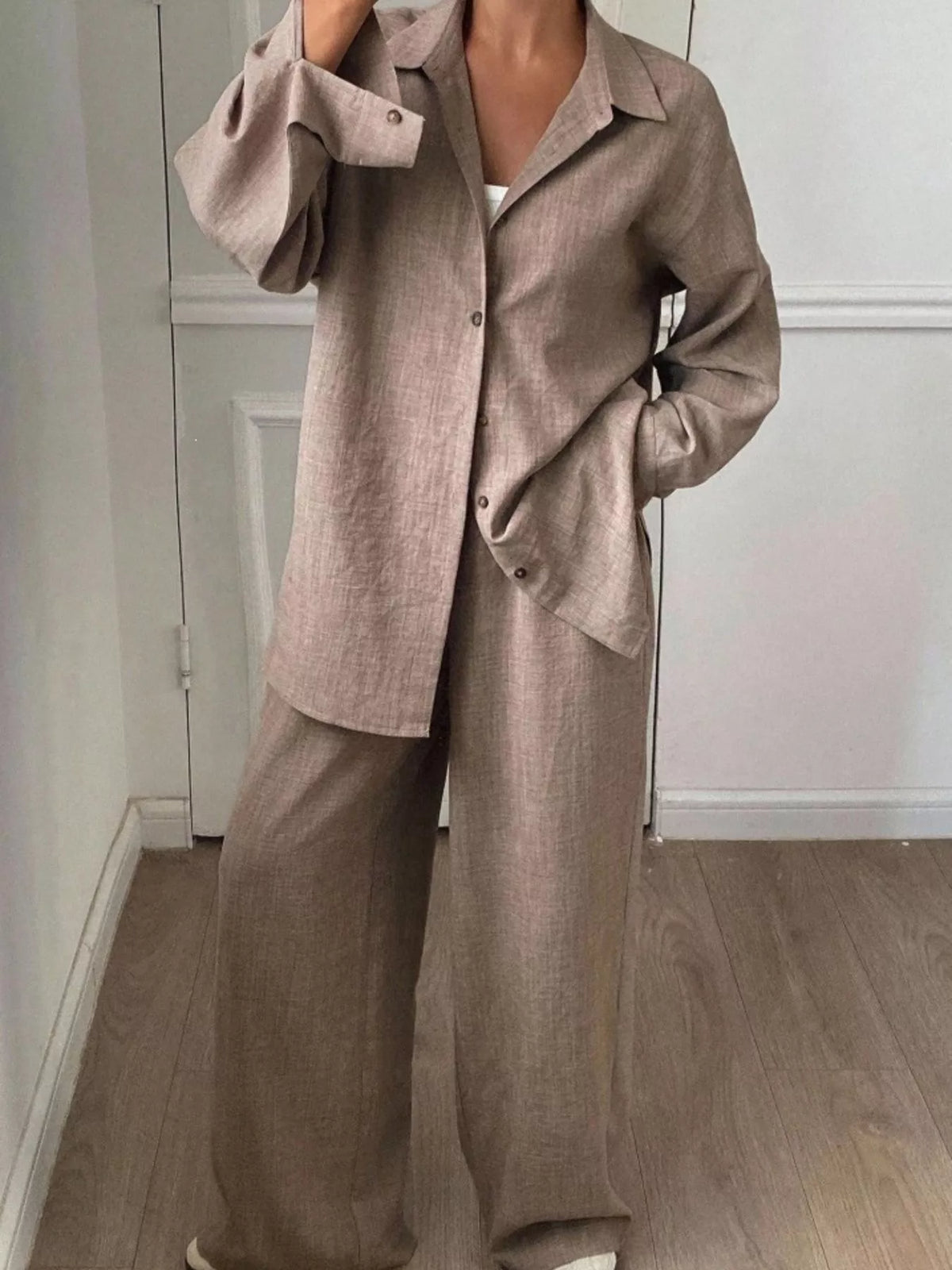 Trendsi long sleeve button-up shirt and wide-leg pants set, featuring a stylish, coordinated outfit with classic design and comfortable fit.