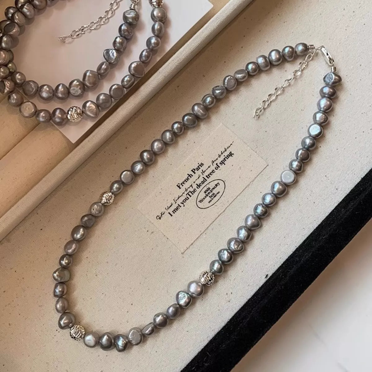 Elegant pearl choker necklace from Plush Fashion Hub featuring lustrous white pearls and a sleek, modern design.