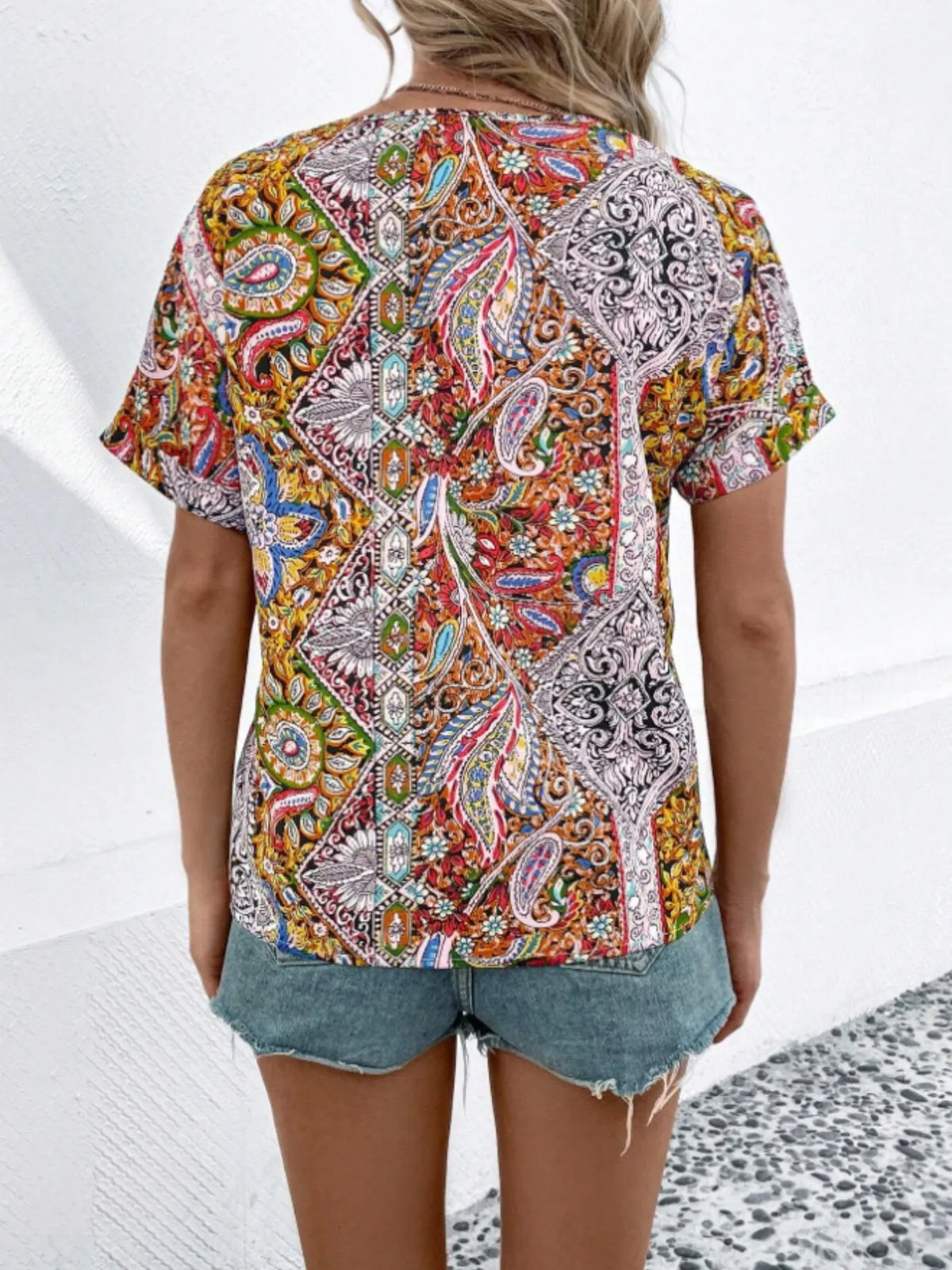 Bohemian paisley V-neck short sleeve T-shirt by Plush Fashion Hub featuring vibrant pattern and relaxed fit.