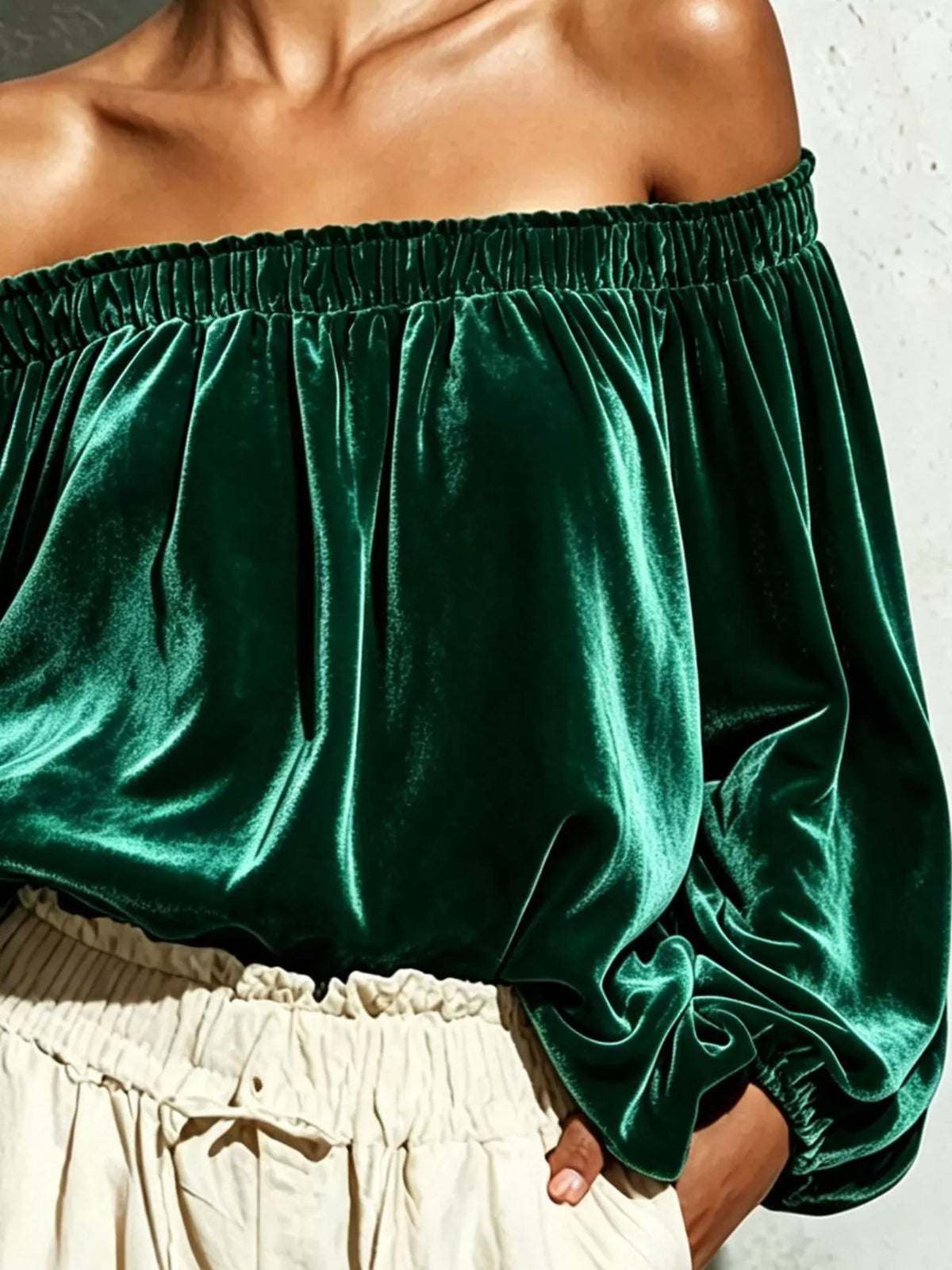 Off-shoulder velvet long sleeve T-shirt from Trendsi, featuring a soft black fabric and stylish off-shoulder design.